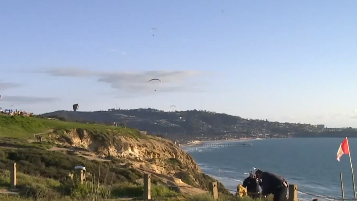 Stunned witnesses said the paragliders were "falling out of the sky" after colliding.