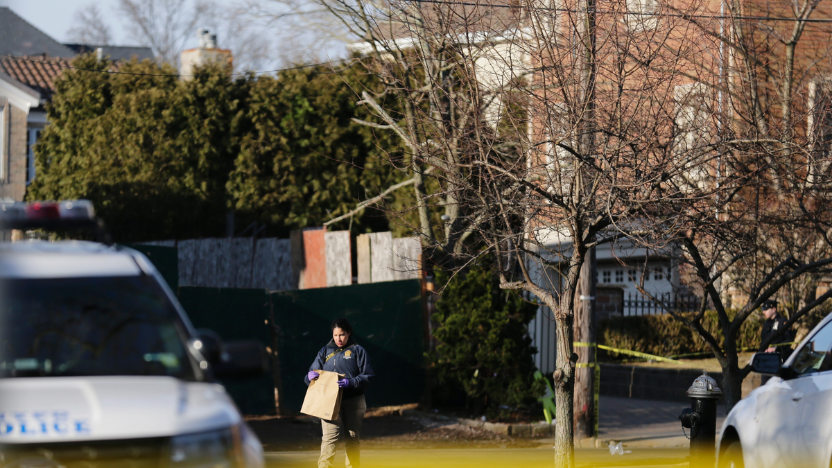 Police work near the scene where an alleged leader of the Gambino crime family was shot and killed in the Staten Island borough of New York, Thursday, March 14, 2019. Francesco "Franky Boy" Cali, 53, was found with multiple gunshot wounds to his body at his home Wednesday night. (AP Photo/Seth Wenig)