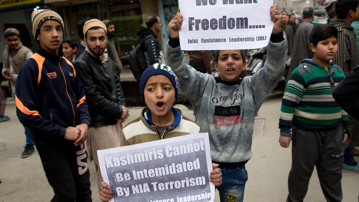 Kashmiri children hold placards and shout freedom slogans in Srinagar, Indian controlled Kashmir, Friday, March 1, 2019. India has banned Jama'at-e-Islami, a political-religious group in Kashmir, in a sweeping and ongoing crackdown against activists seeking the end of Indian rule in the disputed region amid the most serious confrontation between India and Pakistan in two decades. (AP Photo/ Dar Yasin)