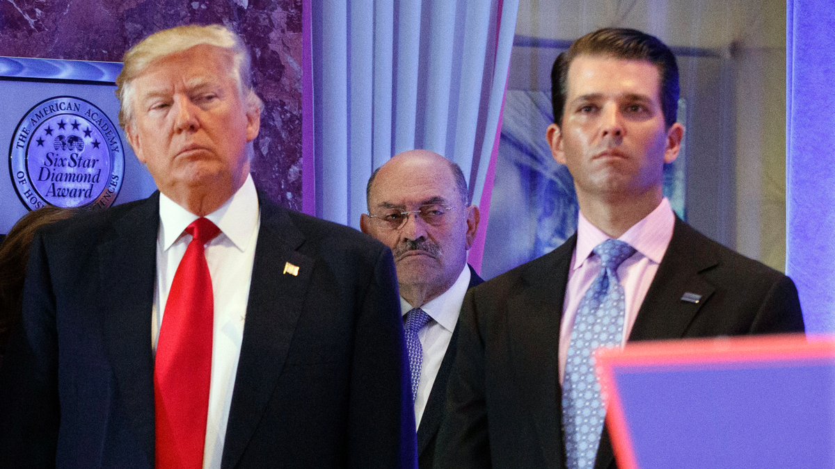 FILE - In this Jan. 11, 2017, file photo, Allen Weisselberg, center, stands between President-elect Donald Trump, left, and Donald Trump Jr., at a news conference in the lobby of Trump Tower in New York. 
