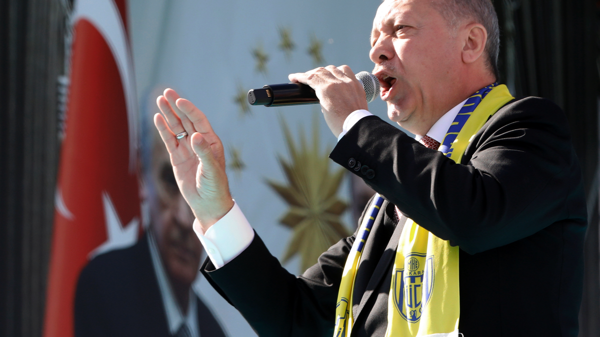 Turkey's President Recep Tayyip Erdogan sings a political song before his address to the supporters of his ruling Justice and Development Party, AKP, during a rally in Ankara, Turkey