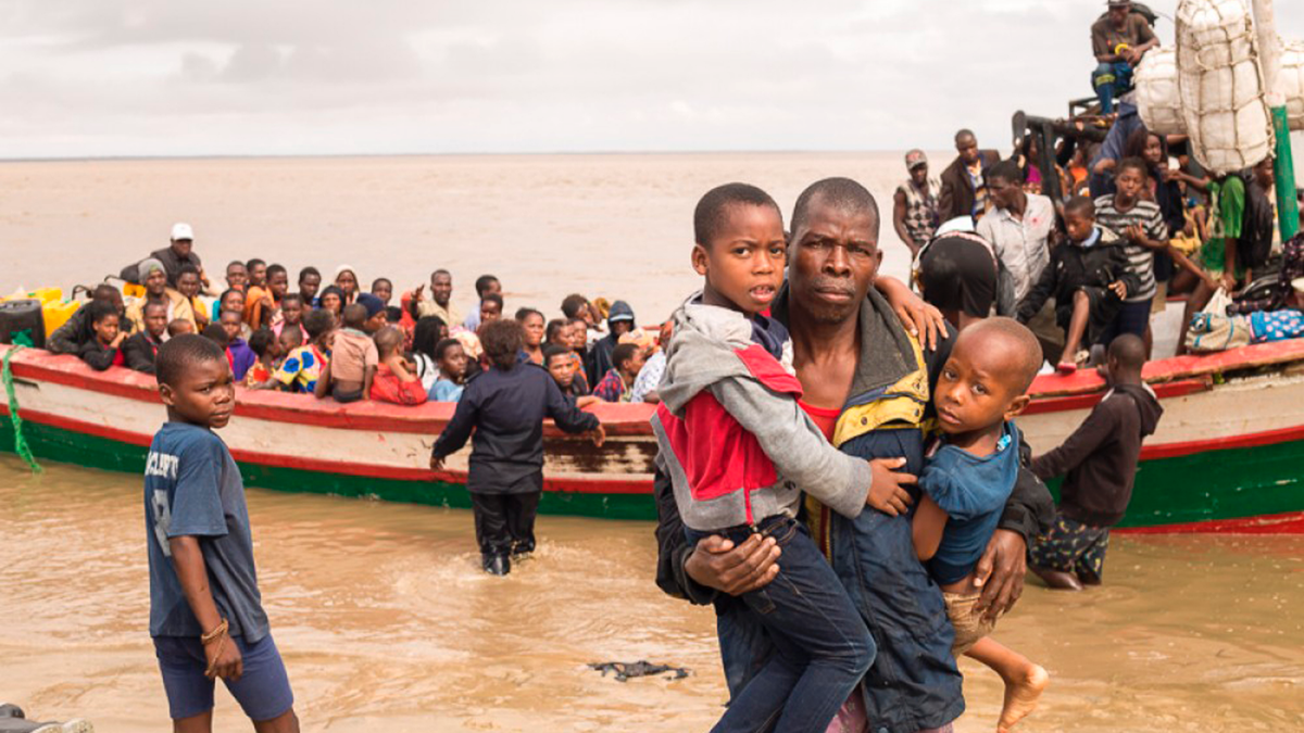 In this photo supplied by the Red Cross Red Crescent Climate Centre survivors of Cyclone Idai arrive by rescue boat in Beira, Mozambique, Thursday, March 21, 2019. The confirmed death toll in Mozambique, Zimbabwe and Malawi surpassed 500, with hundreds more feared dead in towns and villages that were completely submerged. (Photo -Denis Onyodi - Red Cross Red Crescent Climate Centre via AP)
