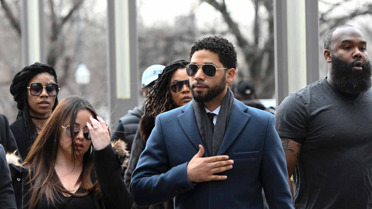 Empire actor Jussie Smollett, center, arrives at the Leighton Criminal Court Building for his hearing on Thursday, March 14, 2019, in Chicago.