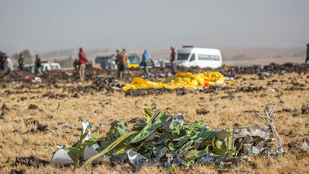 Parts of the plane wreckage with rescue workers at the crash site at Bishoftu, or Debre Zeit, outside Addis Ababa, Ethiopia, Monday, March 11, 2019, where Ethiopia Airlines Flight 302 crashed Sunday.