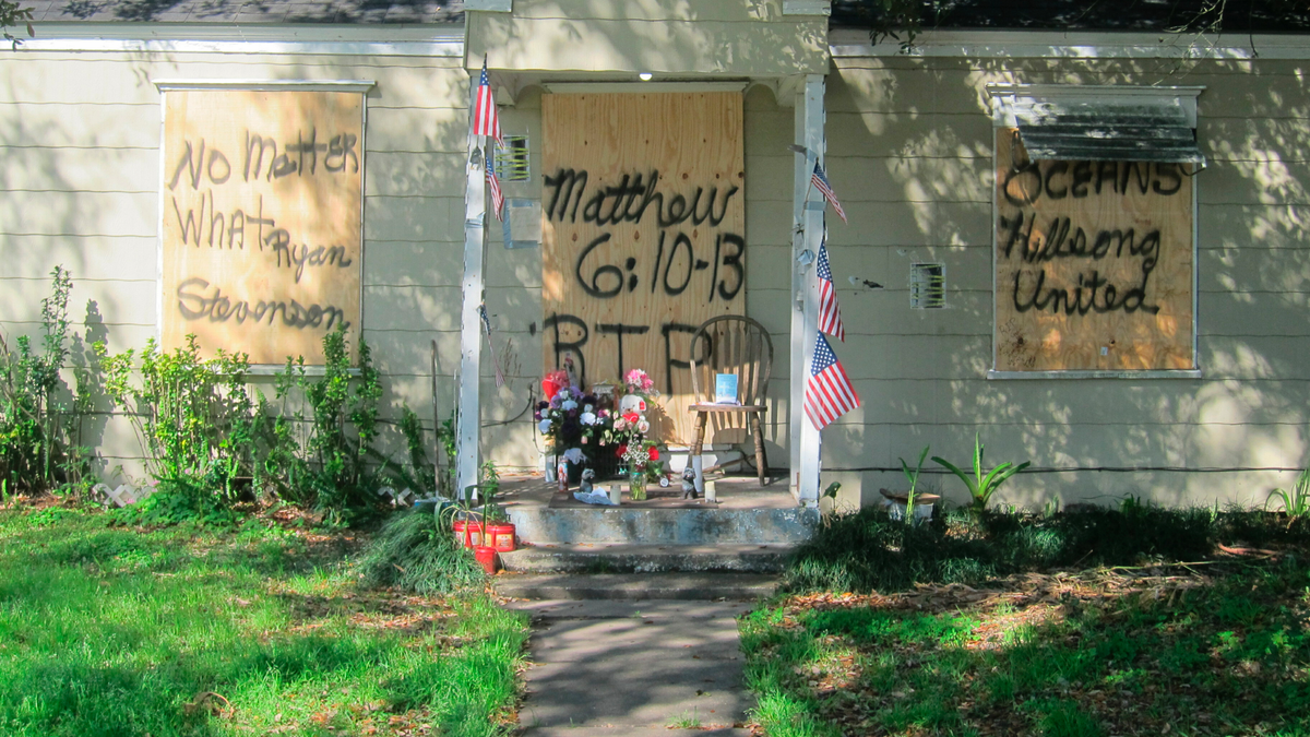 A makeshift memorial was set up in front of Tuttle and Nicholas' home following the raid. (AP Photo/Juan Lozano)