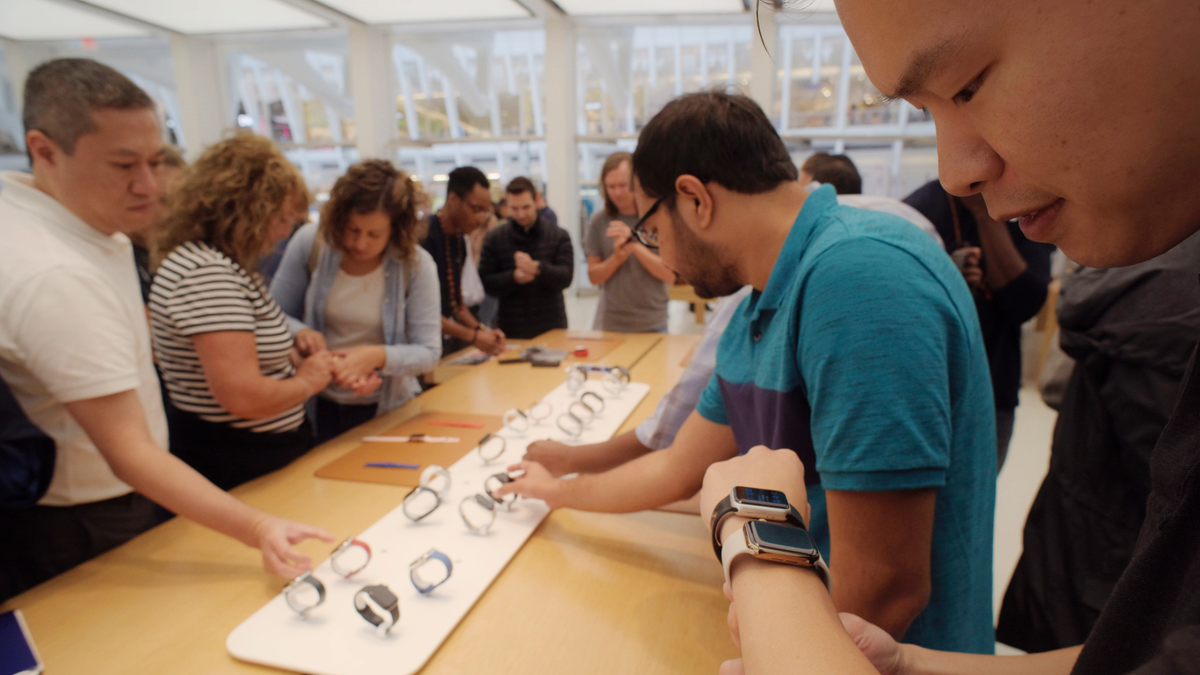 FILE- In this Sept. 21, 2018 file photo customers look at Apple Watches at an Apple store in New York. (AP Photo/Patrick Sison, File)
