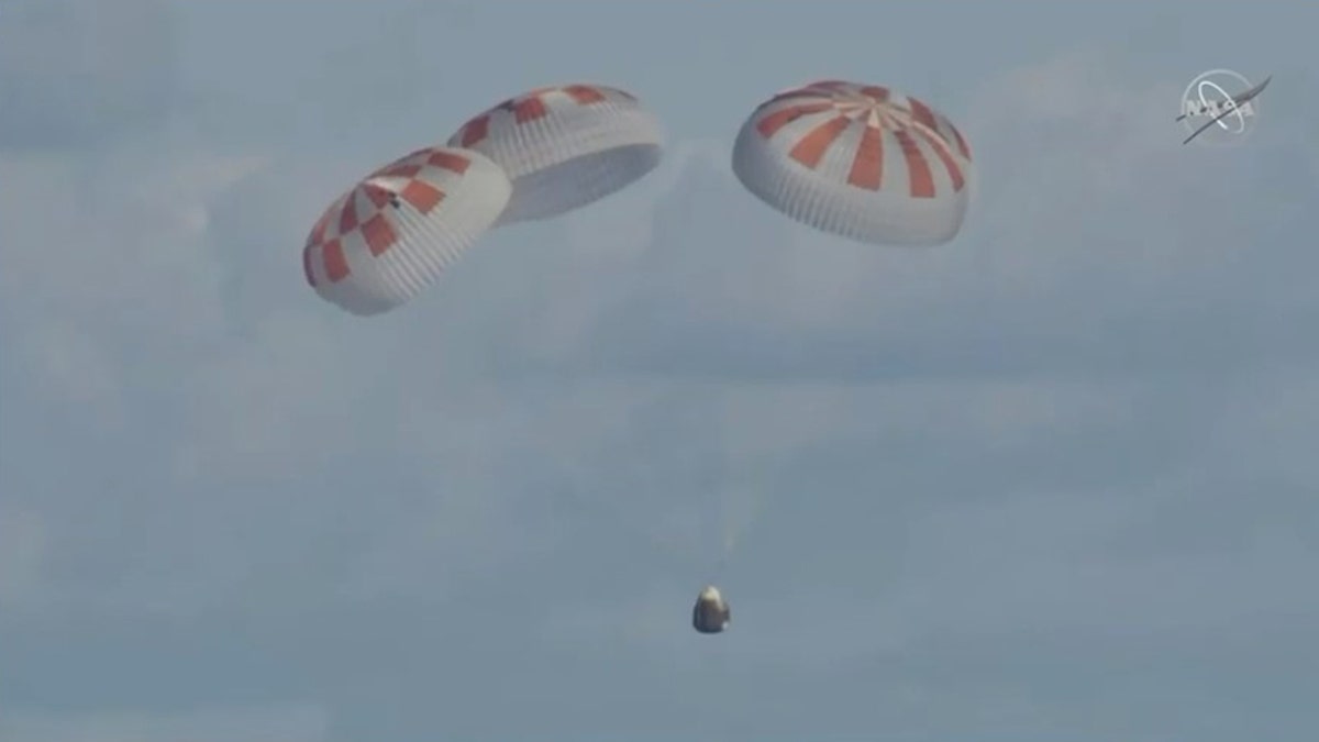 Crew Dragon deployed its four main parachutes before splashing down in the Atlantic Ocean. (NASA TV)