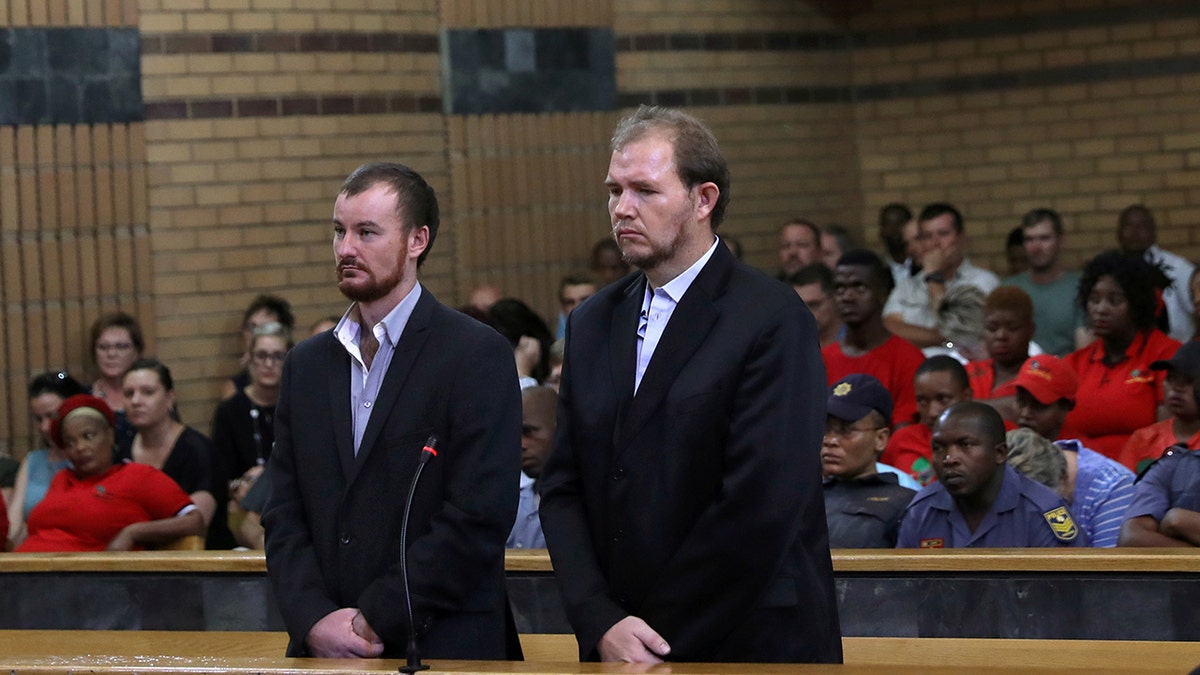 Pieter Doorewaard and Phillip Schutte, found guilty of killing a teenager, Matlhomola Mosweu, who was thrown from a moving vehicle, look on during sentencing in Mafikeng, South Africa March 6, 2019.
