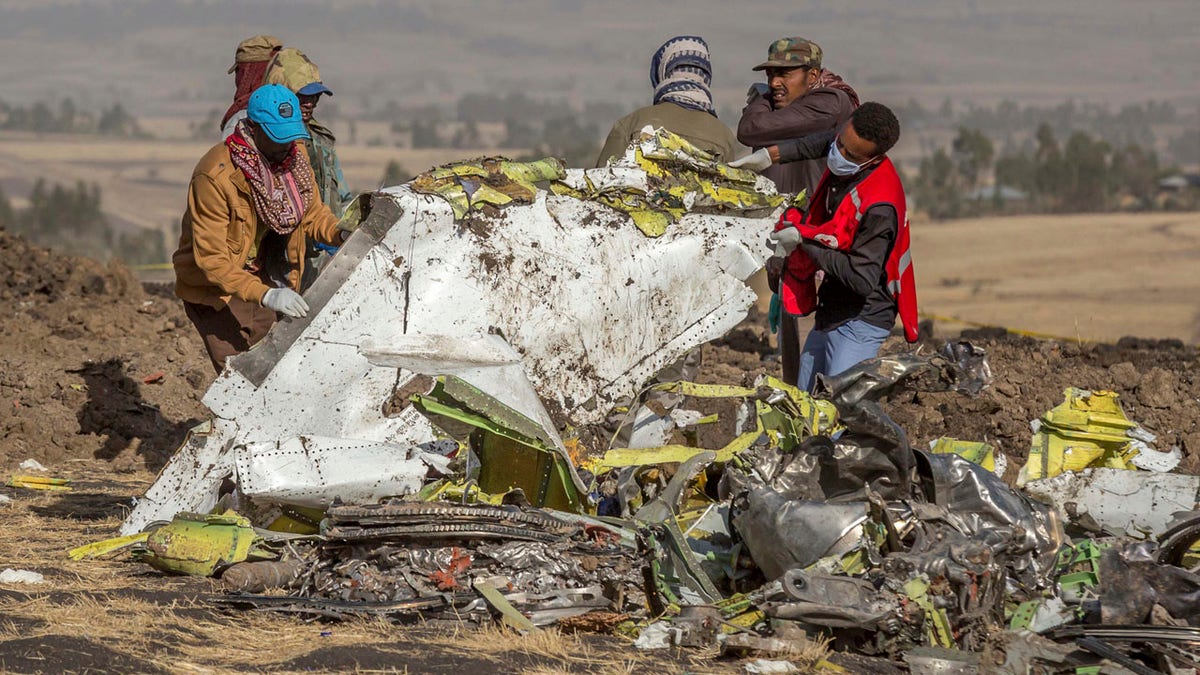 Rescuers work at the scene of an Ethiopian Airlines flight crash near Bishoftu, or Debre Zeit, south of Addis Ababa, Ethiopia, Monday, March 11, 2019.
