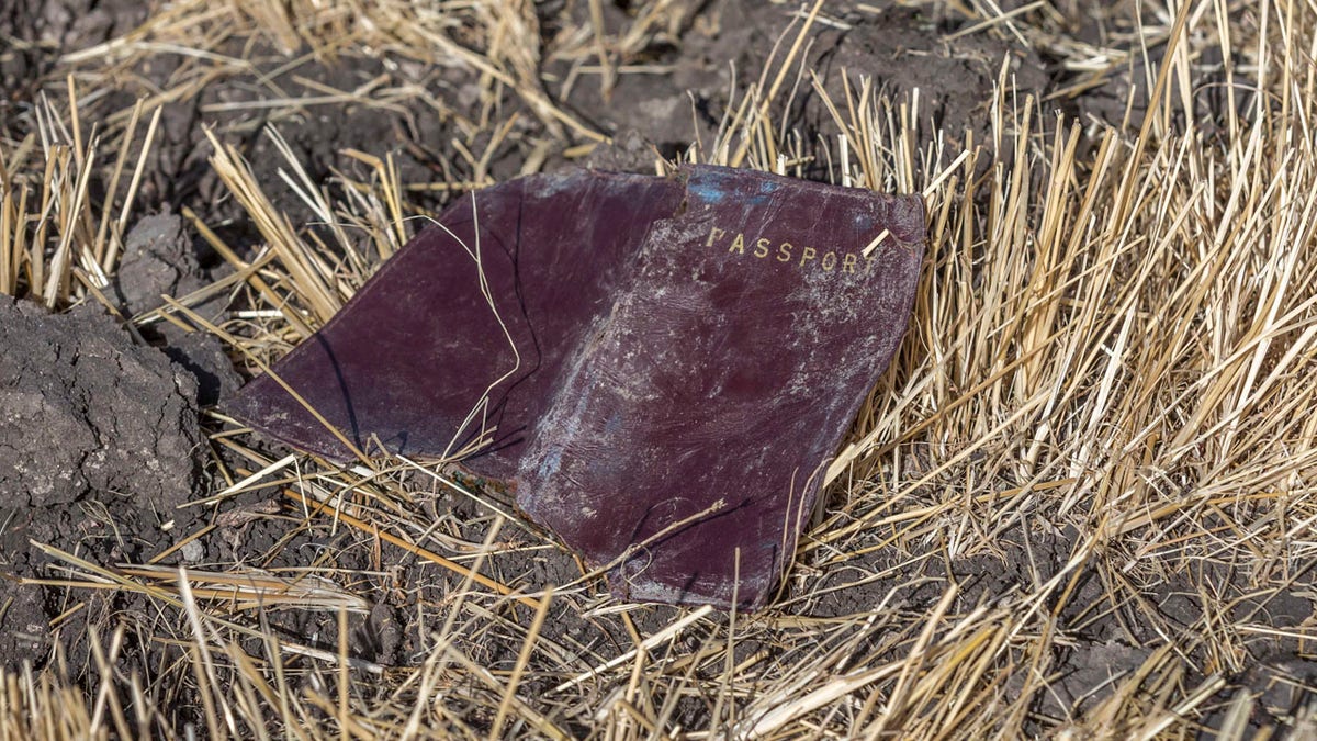 A passenger passport lies on the ground at the scene of an Ethiopian Airlines flight crash near Bishoftu, or Debre Zeit, south of Addis Ababa, Ethiopia, Monday, March 11, 2019.