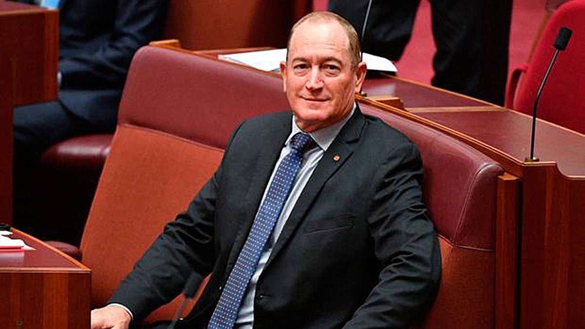 Australian senator Fraser Anning sits in the chamber during a session at Parliament House in Canberra, Wednesday, Aug. 15, 2018. Aning is being condemned for his speech in Parliament advocating reviving a white-only immigration policy and using the term "final solution" in calling for a vote on which migrants to admit into the country. (Mick Tsikas/AAP Image via AP)