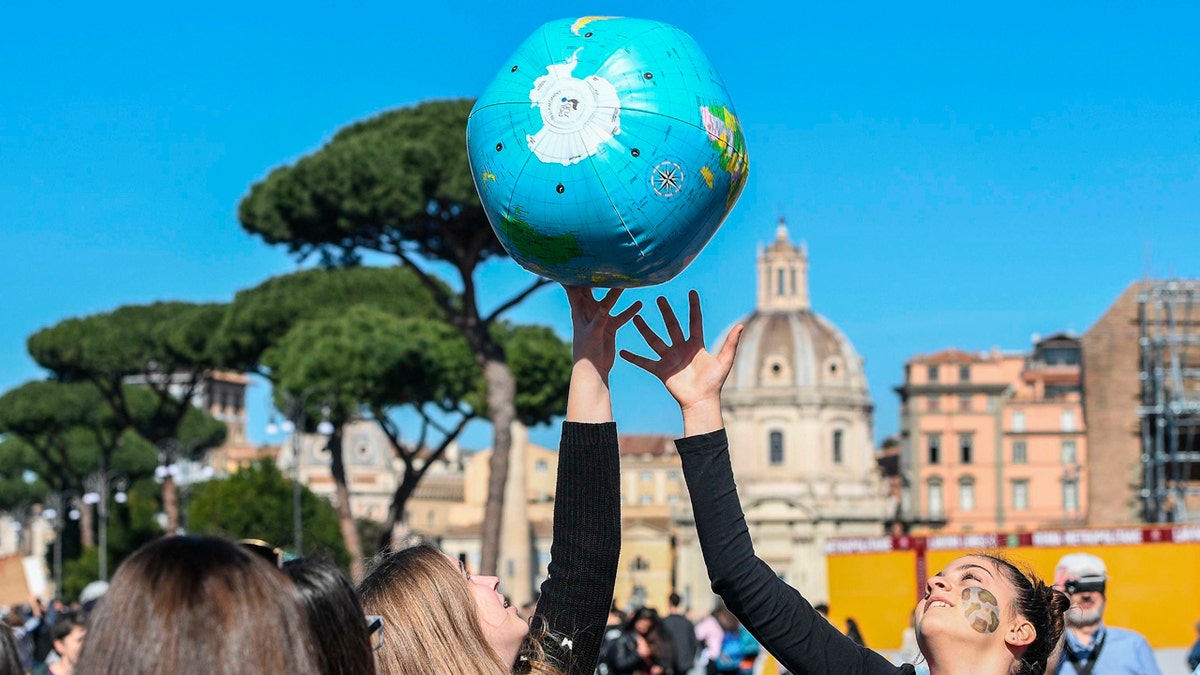 Students in Rome play with an inflatable globe as they march to demand action on climate change, March 15, 2019.