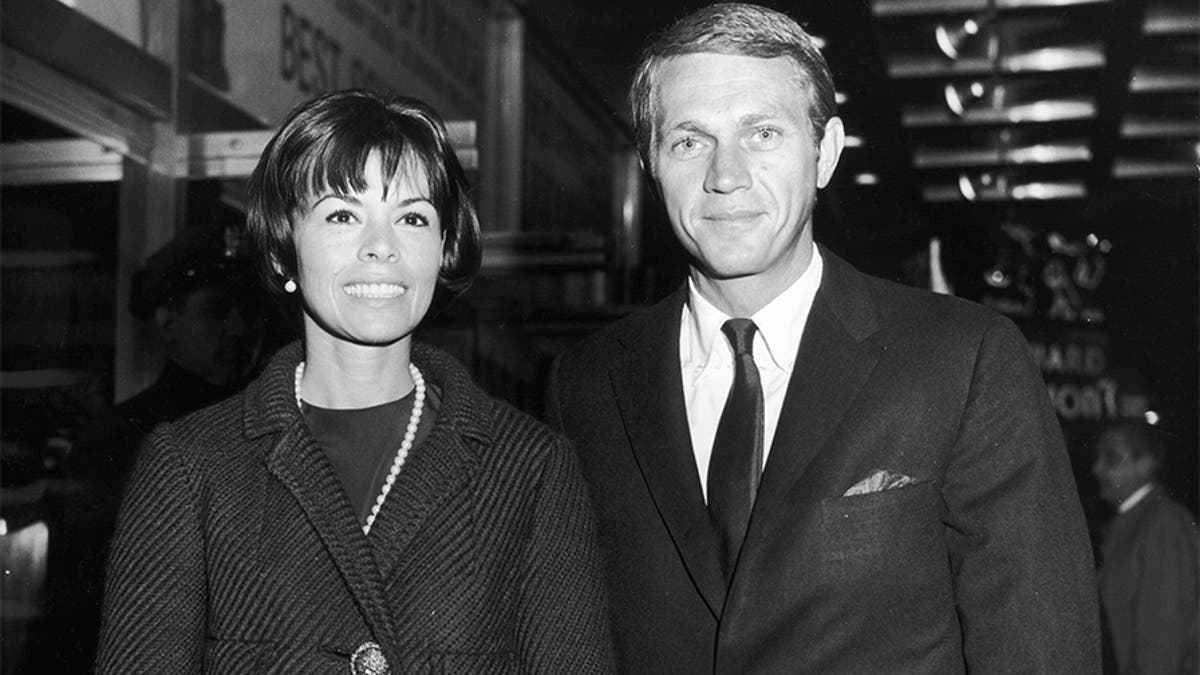 Circa 1965: American actor Steve McQueen (1930-1980) and his first wife, actress Neile Adams, smile as they attend a Broadway play, New York City.