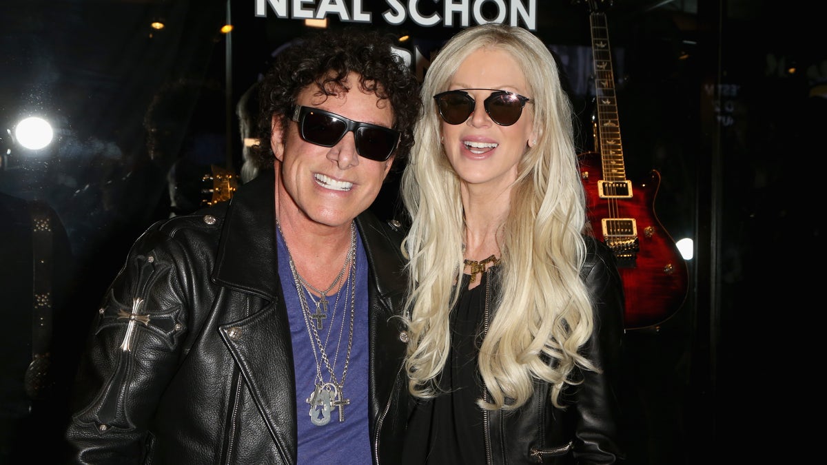 Guitarist Neal Schon (L) of Journey and his wife, television personality Michaele Schon are reportedly suing Live Nation for emotional distress.