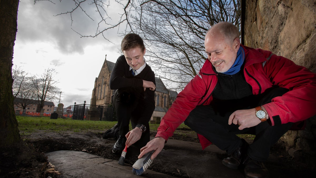 Mark McGettigan and Professor Stephen Driscoll of the University of Glasgow examine one of the rediscovered stones at Govan Old Parish Church.