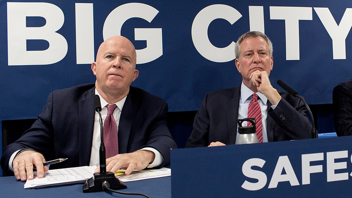 New York City Police Commissioner James O’Neill (left) said on Monday that the department has a new five-point plan to combat rising violent crime