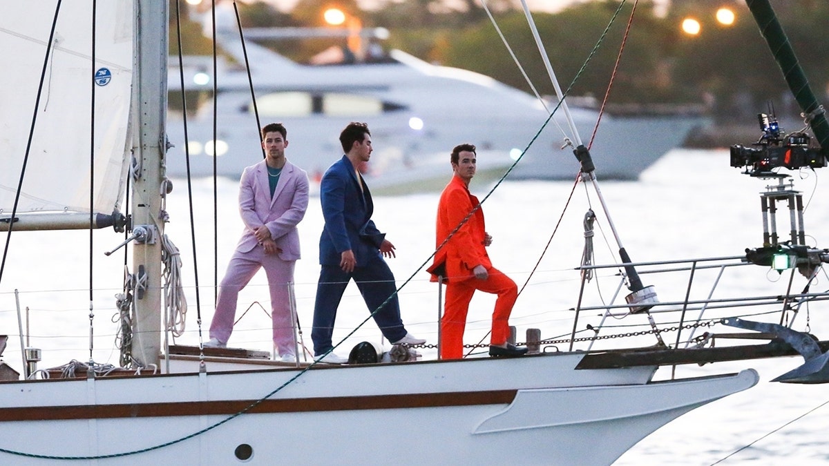 The Jonas Brothers were spotted in Miami on a sailboat filming what appears to be a video for an upcoming project after recently surprising fans with new music. 