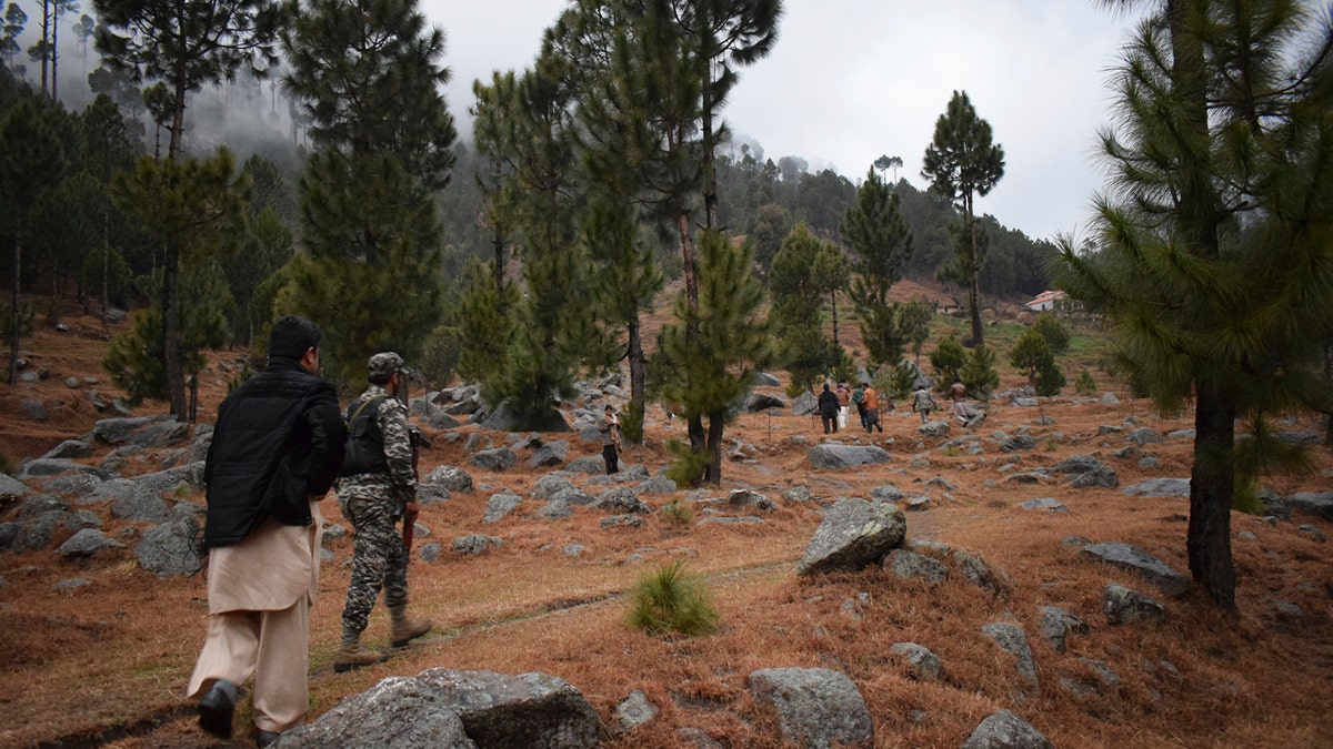 Pakistani reporters and troops visit the site of an Indian airstrike in Jaba, near Balakot, Pakistan, Tuesday, Feb. 26, 2019.