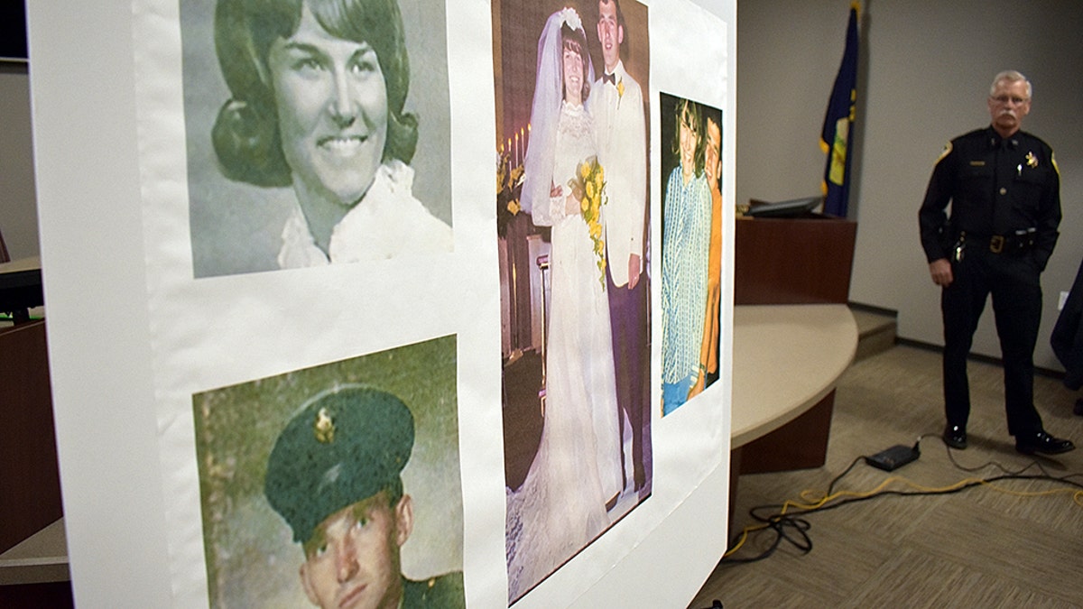 Photos of Linda and Clifford Bernhardt, who were killed in 1973, are displayed at a press conference at the Yellowstone County administrative offices in Billings, Montana on Monday, March 25, 2019. Yellowstone County Sheriff Mike Linder, pictured at right, says authorities have identified the couple's now-deceased killer.