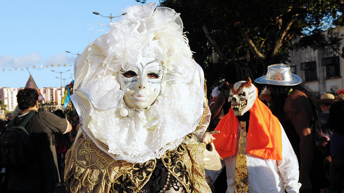 Revelers pose during the Carnival parade in the streets of Fort-de-France on the French Caribbean island of Martinique, on February 10, 2013. The Carnaval started on February 9, 2013 and will run until Ash Wednesday on February 13, 2013 when Vaval, a giant papier-mache figure symbolizing the king of the carnival, is burned. AFP PHOTO/ JEAN-MICHEL ANDRE (Photo credit should read JEAN-MICHEL ANDRE/AFP/Getty Images)