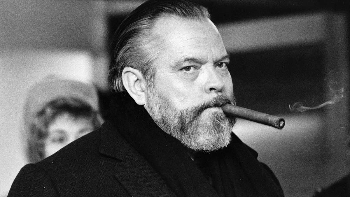 Orson Welles with a cigar in his mouth