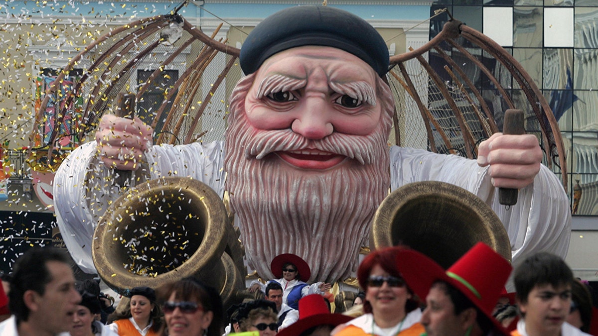 Patras, GREECE: Participants of the most famous Greek carnival in the city of Patras, parade in the streets to mark the last day of the carnival 05 March 2006. Thousands of visitors arrived to take part in the celebrations in the city of Patras, which is the European Capital of Culture for the year 2006. AFP PHOTO/Louisa Gouliamaki (Photo credit should read LOUISA GOULIAMAKI/AFP/Getty Images)