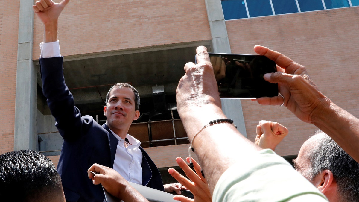 Venezuelan opposition leader Juan Guaido, who many nations have recognized as the country's rightful interim ruler, greets supporters after his arrival at the Simon Bolivar International airport in Caracas, Venezuela March 4, 2019. REUTERS/Carlos Jasso - RC1427AEED70