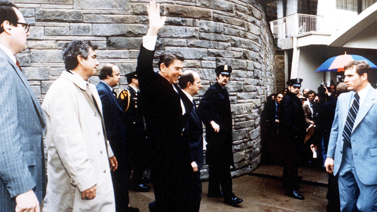 President Reagan waves to onlookers moments before an assassination attempt by John Hinckley Jr. in Washington in 1981.