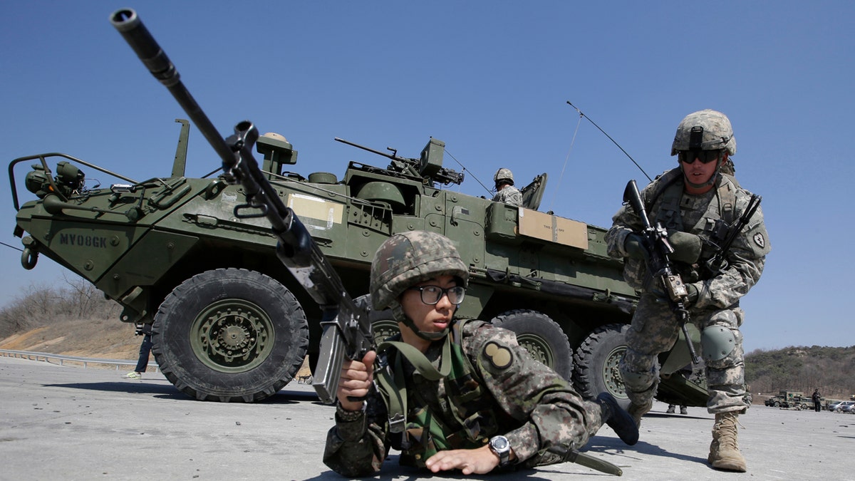 In this March 25, 2015, file photo, U.S. Army soldiers from the 25th Infantry Division's 2nd Stryker Brigade Combat Team and a South Korean Army soldier participate in a demonstration of the combined arms live-fire exercise during the annual joint military exercise Foal Eagle between South Korea and the United States at the Rodriquez Multi-Purpose Range Complex in Pocheon, north of Seoul, South Korea. (AP Photo/Lee Jin-man, File)