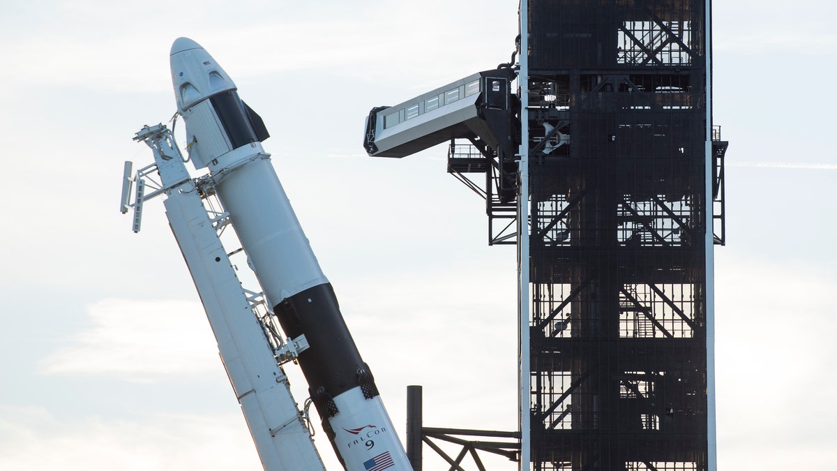 A SpaceX Falcon 9 rocket with the company's Crew Dragon spacecraft onboard is seen as it is raised into a vertical position on the launch pad at Launch Complex 39A as preparations continue for the Demo-1 mission, Thursday, Feb. 28, 2019.
