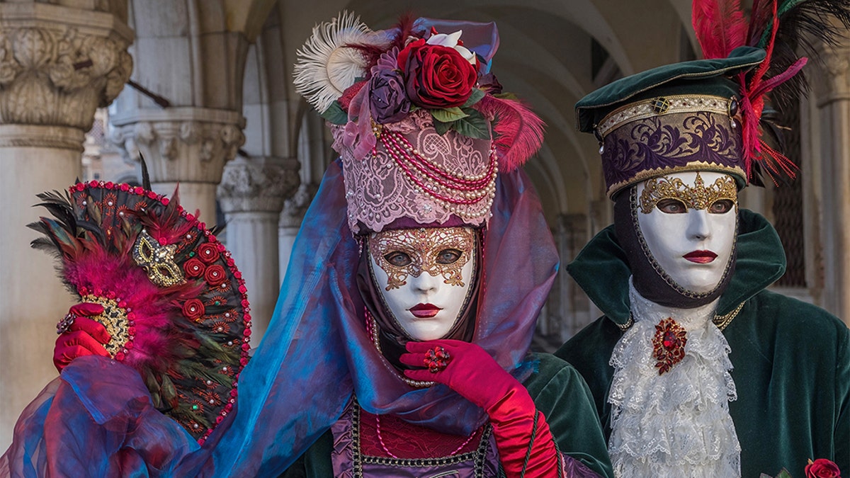 VENICE, ITALY - FEBRUARY 04: People wearing carnival costumes pose in St. Mark square during the Flight of Angel on February 4, 2018 in Venice, Italy. The theme for the 2018 edition of Venice Carnival is 'Playing' and will run from 27 January to 13 February. (Photo by Awakening/Getty Images)