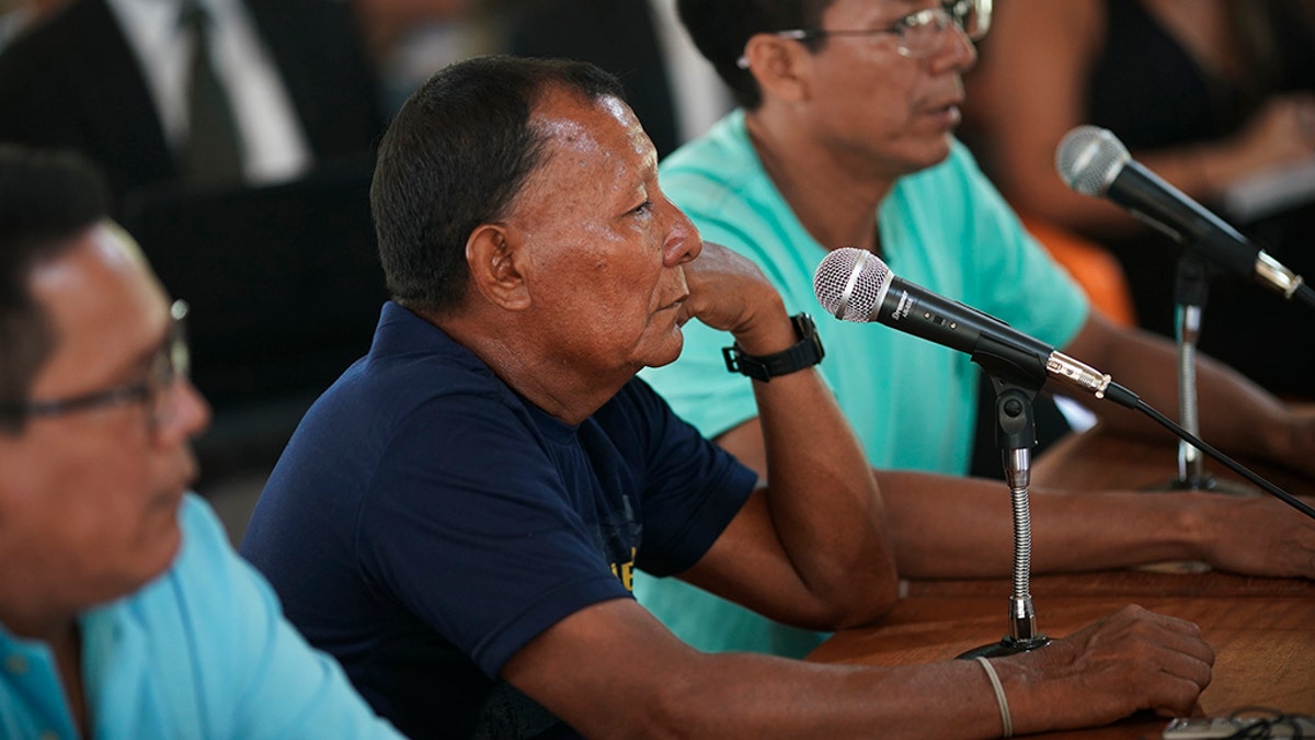 Bare Bornaldo Waimiri sits before a microphone as he gives testimony about alleged crimes committed by the Brazilian dictatorship in the 1970s during a hearing on the Waimiri-Atroari reserve in Brazil's Amazon state, Wednesday, Feb. 27, 2019. “I lost my father, my mother, my sister and my brother,” Bornaldo said. (AP Photo/Victor R. Caivano)