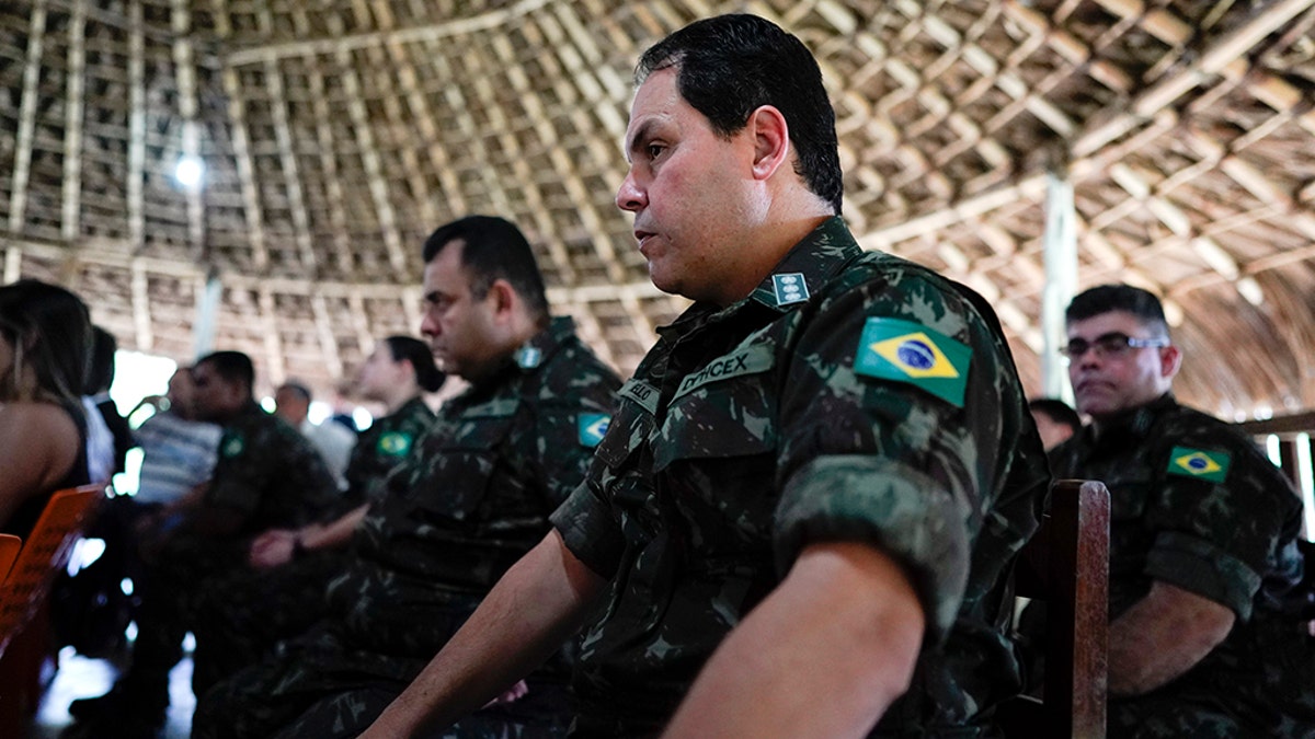 Military officers listen to the testimony of Temehe Tomas Waimiri about alleged crimes committed by Brazil's dictatorship in the 1970s during a hearing on the Waimiri-Atroari reserve, in Brazil's Amazon state, Wednesday, Feb. 27, 2019. Now elderly, indigenous men described horrific scenes that put a spotlight on Brazil’s military, which denies attacking the tribe. (AP Photo/Victor R. Caivano)