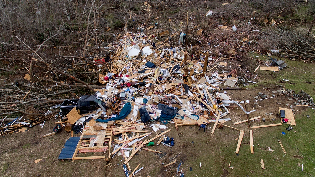 Debris litters a yard the day after a deadly tornado damaged a home in Beauregard, Ala., Monday, March 4, 2019.