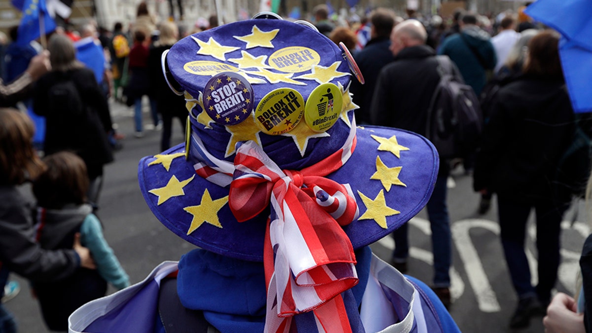 A demonstrator wears a hat decorated with the EU and British colors during a Peoples Vote anti-Brexit march in London, Saturday.