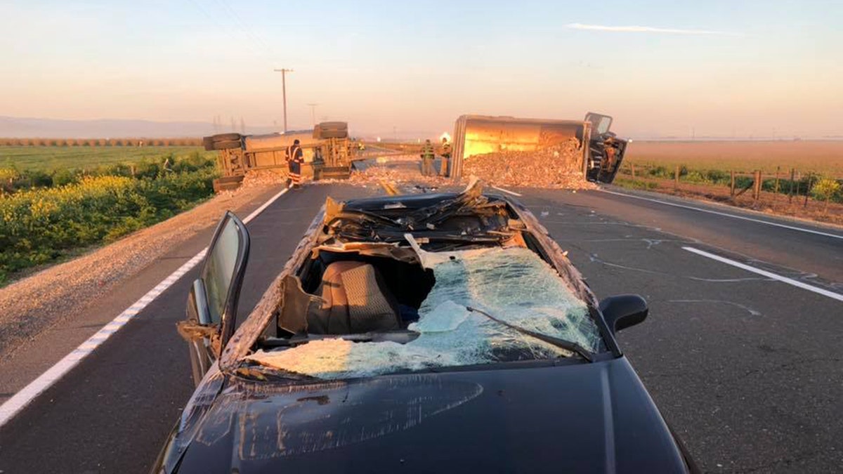 A Honda being driven on a California roadway “limboed” between a pair of overturned trailers, authorities said Friday, causing significant damage to the car including a shattered front window.