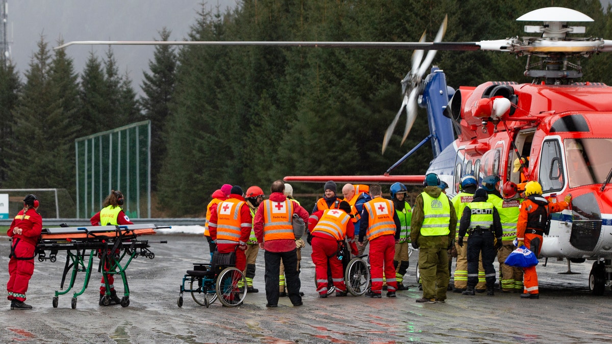 Passengers are helped from a rescue helicopter in Fraena, Norway, on Sunday after being rescued from the Viking Sky cruise ship.