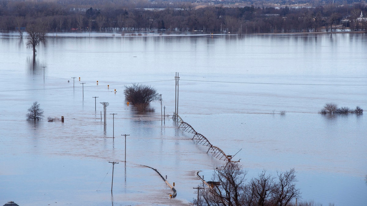 Looking southwest toward Waterloo, Neb., high waters from the Elkhorn River cover Maple Street on Saturday. (Jeff Bundy/Omaha World-Herald via AP)