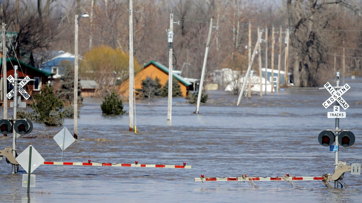 A railroad crossing is flooded with water from the Platte River, in Plattsmouth, Neb., Sunday, March 17, 2019. (AP Photo/Nati Harnik)