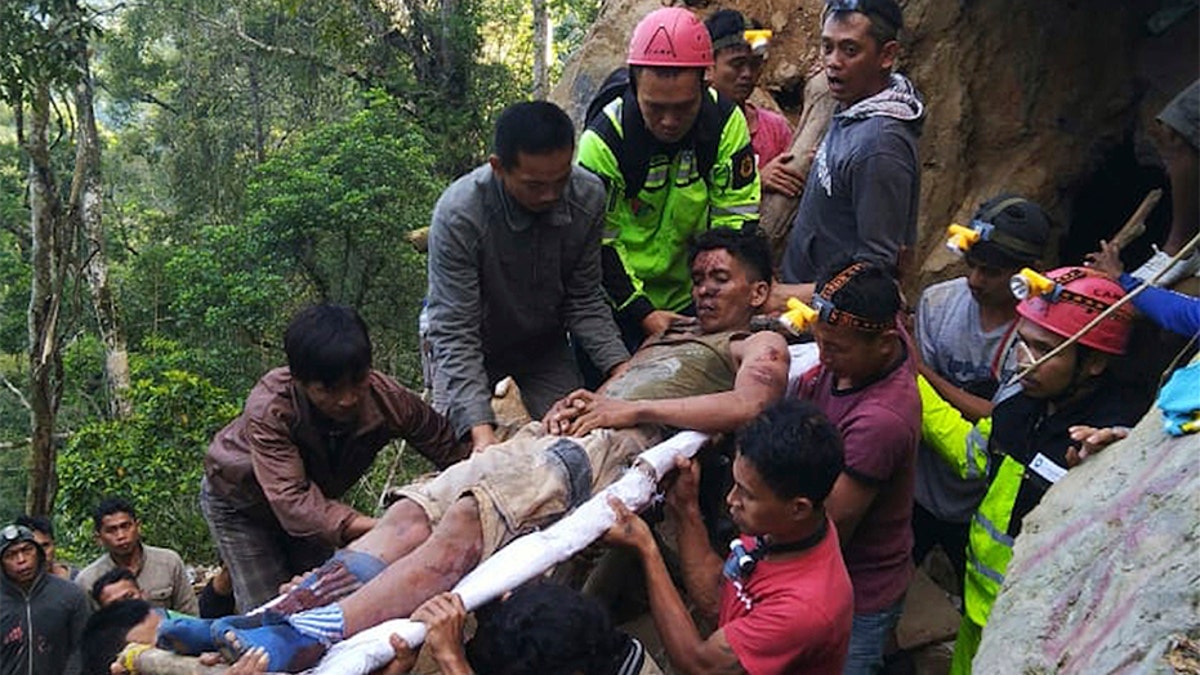 Rescuers evacuate a survivor from inside of the collapsed gold mine.