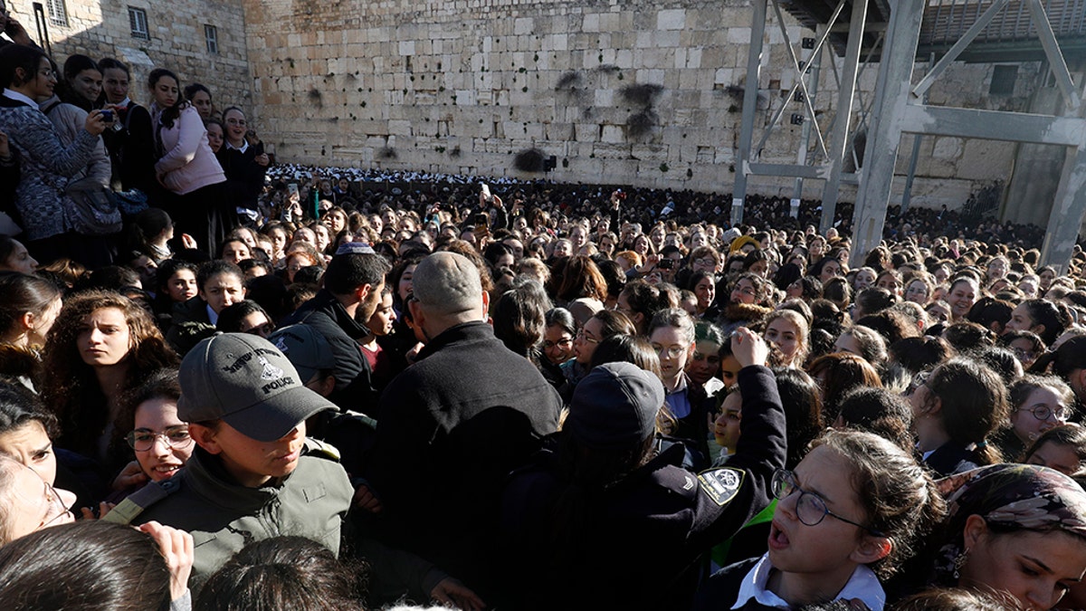 Thousands of Ultra Orthodox Jewish girls gather at Judaism's holiest prayer site of the Western Wall in the Old City of Jerusalem on March 8, 2019, in protest against members of the liberal Jewish religious movement "Women of the Wall" (WOW) praying at the site during an event marking the organization's 30th anniversary and the start of the Jewish month (Rosh Hodesh) of Adar Bet.