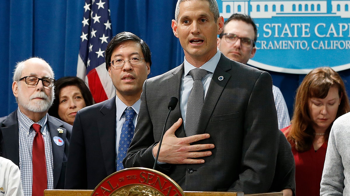 Dr. Eric Ball, center, representing the American Academy of Pediatrics in California, speaks in support of a proposed measure to have public health officials grant medical exemptions for vaccination instead of leaving the power to physicians, during a news conference in Sacramento, Calif.?