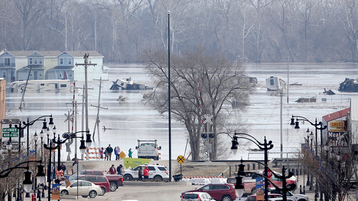People view the rising waters from the Platte and Missouri rivers which flooded areas of Plattsmouth, Neb., in March.