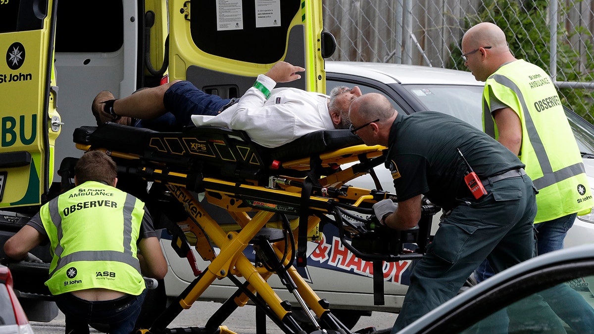 Ambulance staff take a man from outside a mosque in central Christchurch, New Zealand, Friday, March 15, 2019. (AP Photo/Mark Baker)