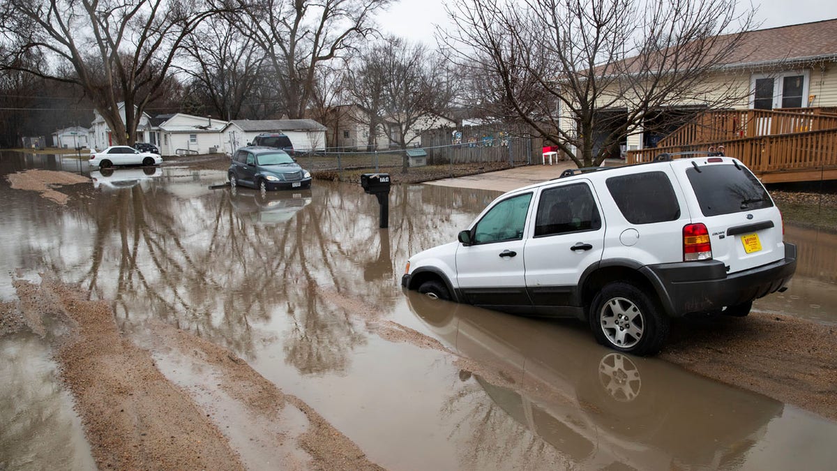 Cars are stuck in floodwaters Tuesday, March 19, 2019, in Fremont, Neb.