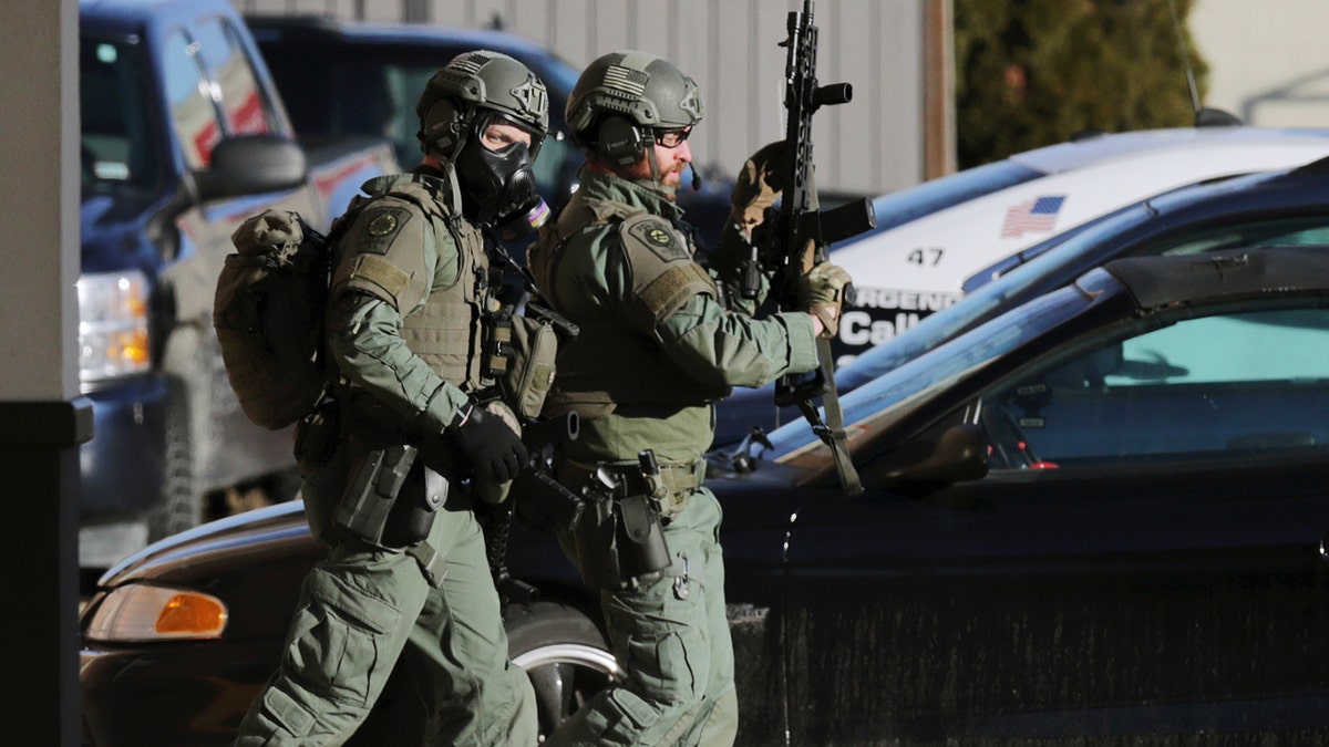 Police officers walks outside the Quality Inn on Thursday, March 28, 2019, in Manchester, N.H.