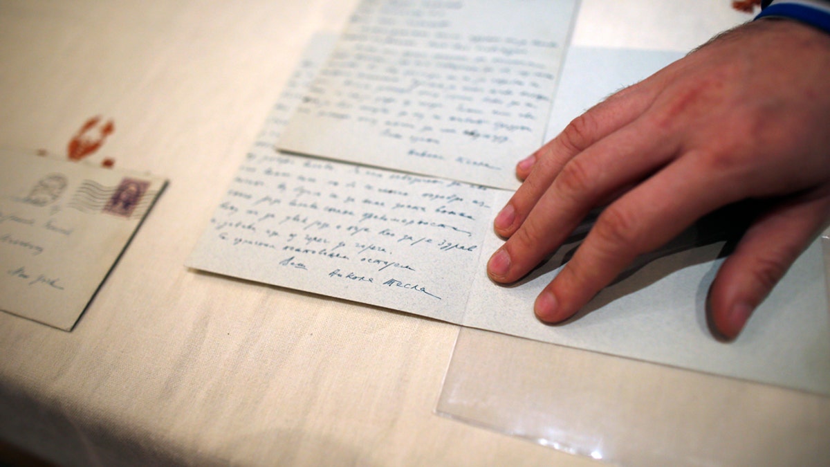 Viktor Lazic from Adligat group displays two letters written by 19th century inventor and electricity pioneer Nikola Tesla in Belgrade, Serbia, Thursday, March 7, 2019. A private culture society in Serbia has made public two letters written by Serb-American inventor and electricity pioneer Nikola Tesla. The Adligat group has told The Associated Press they recently obtained the letters from a collector and verified their authenticity with multiple sources. (AP Photo/Darko Vojinovic)