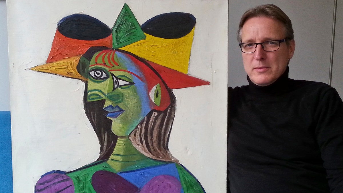 This image released on Tuesday March 26, 2019 by Arthur Brand, shows Dutch art detective Arthur Brand with "Buste de Femme", a recovered Picasso painting.