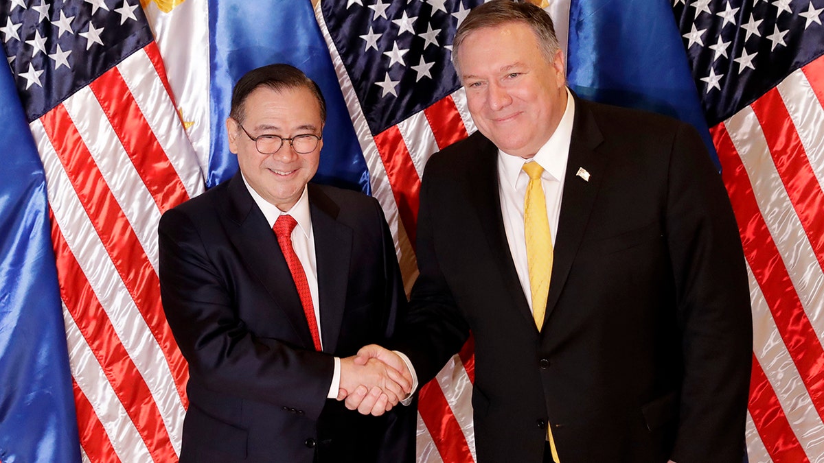 Philippine Foreign Affairs Secretary Teodoro Locsin Jr., left, and U.S. Secretary of State Mike Pompeo shake hands prior to their bilateral meeting in suburban Pasay city, southeast of Manila, Philippines Friday, March 1, 2019. (AP Photo/Bullit Marquez)