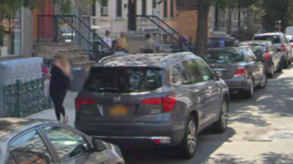 Bystanders can be seen in the footage watching the scene unfold down the block.